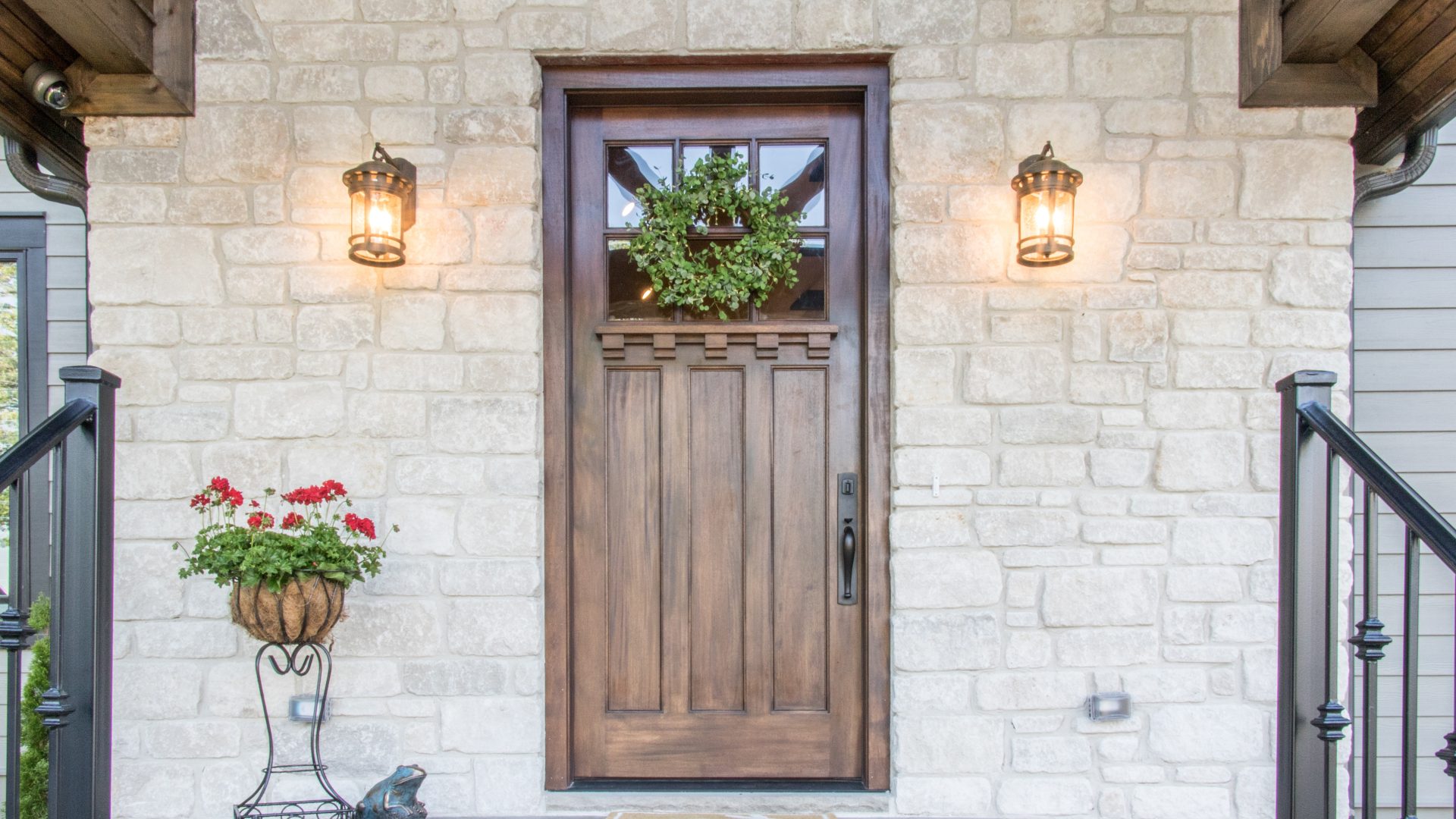 A home with stone siding and a wood entry door