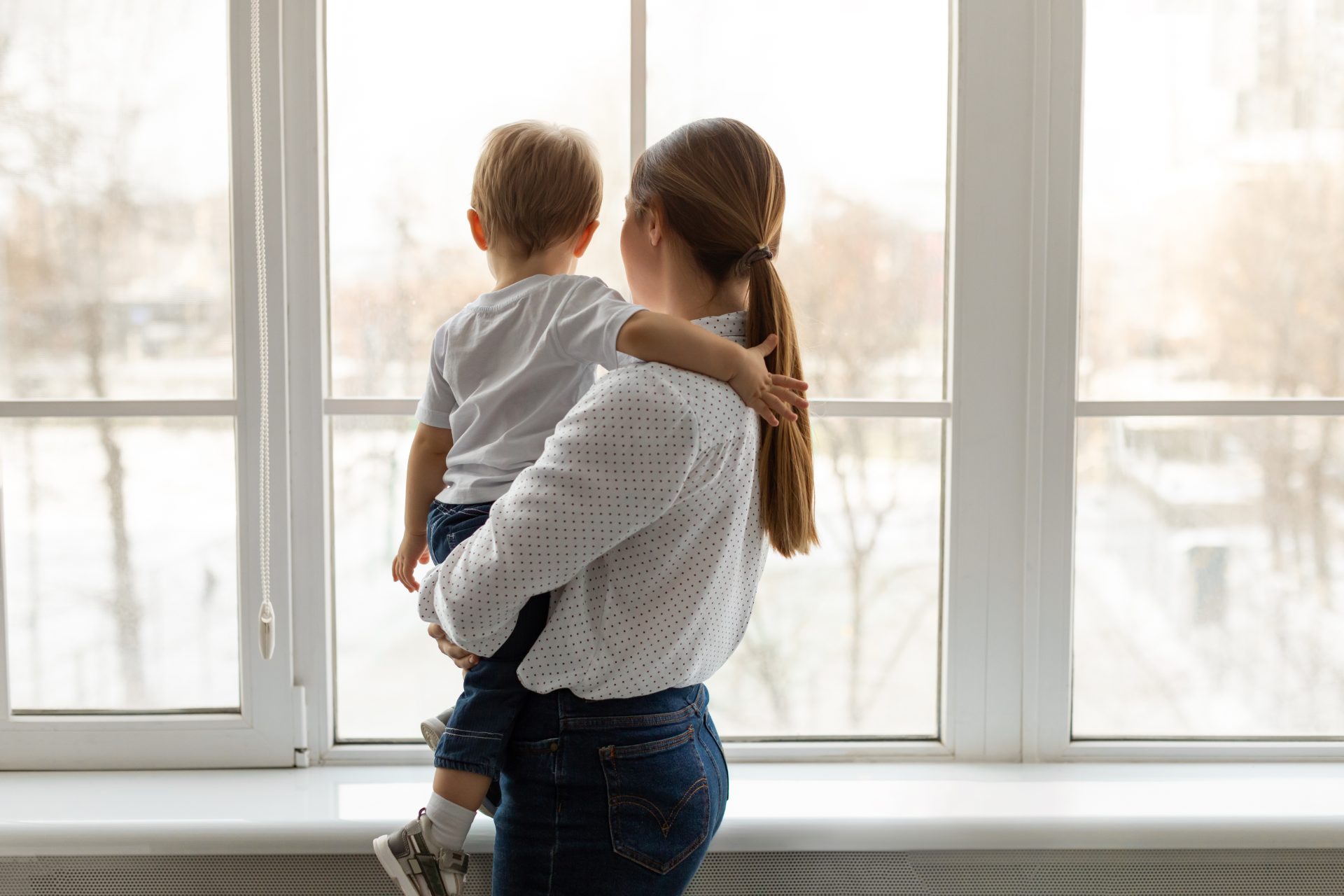Woman And Child Standing In Front Of Newly Installed Windows