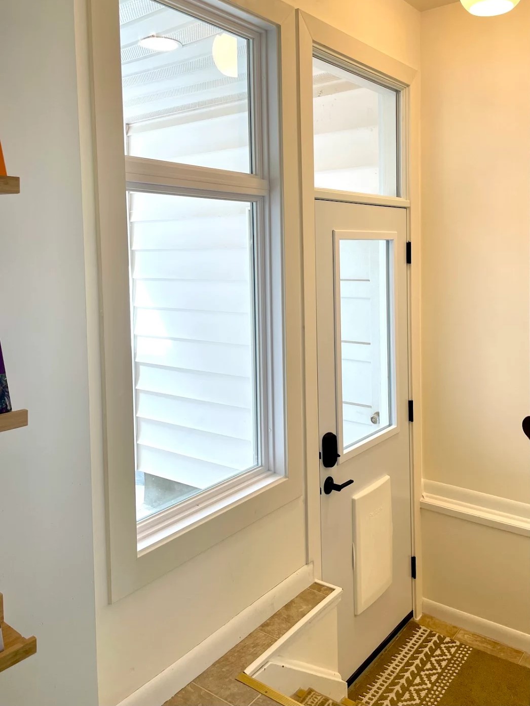 A white back entry door is meticulously installed by GreenFox Windows & Doors in Alberta, CA.
