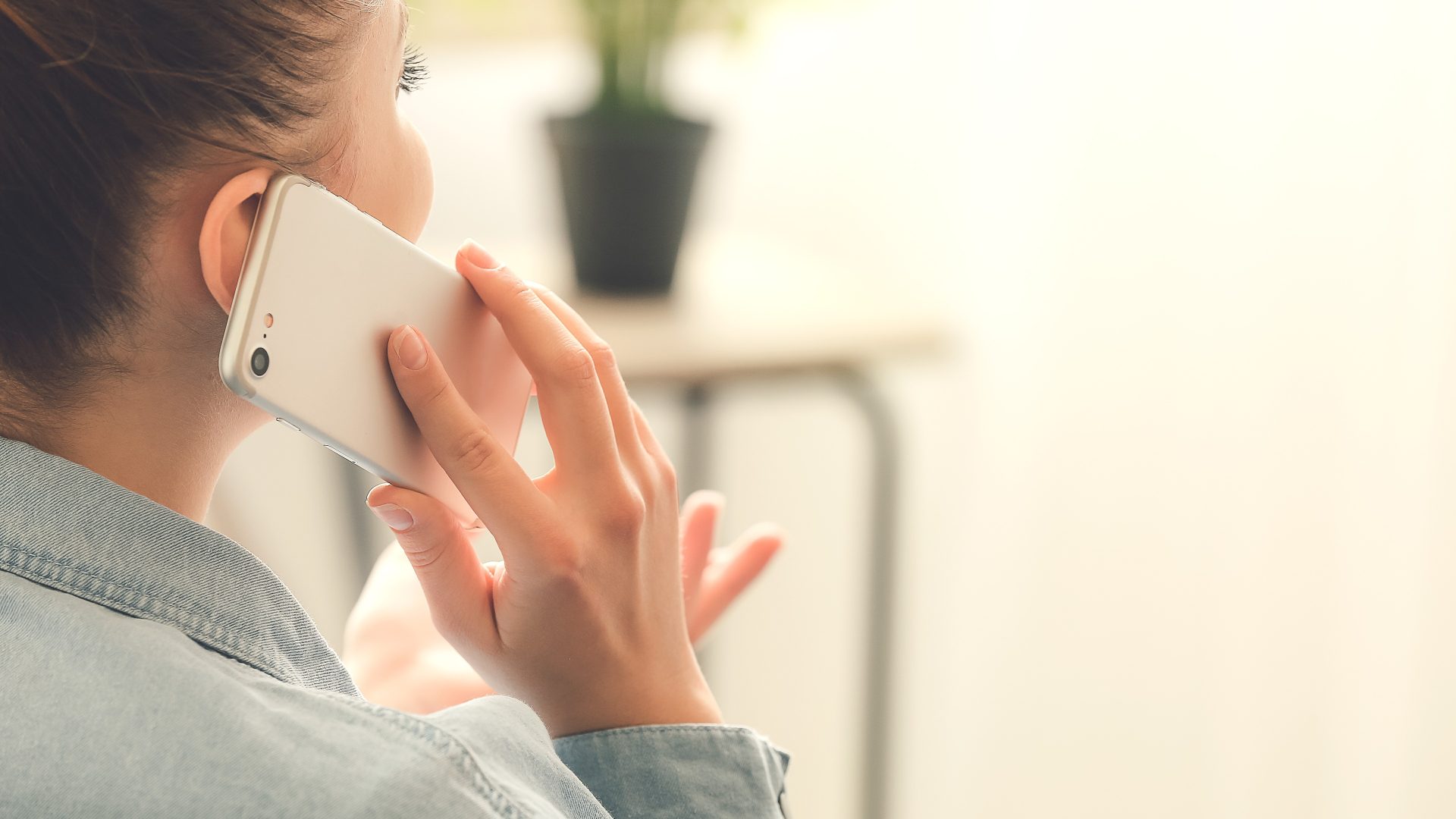 A woman talking on her cell phone at home