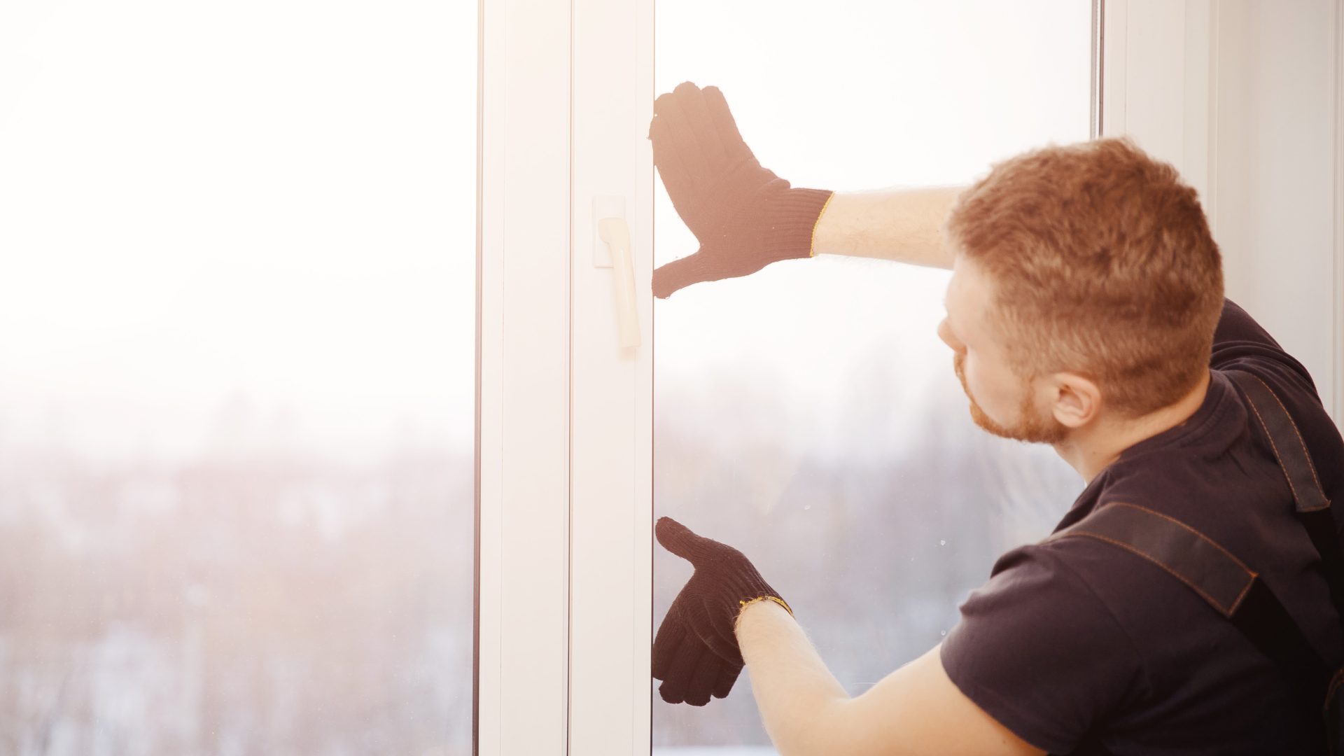 Close view of an installer putting a casement window into place