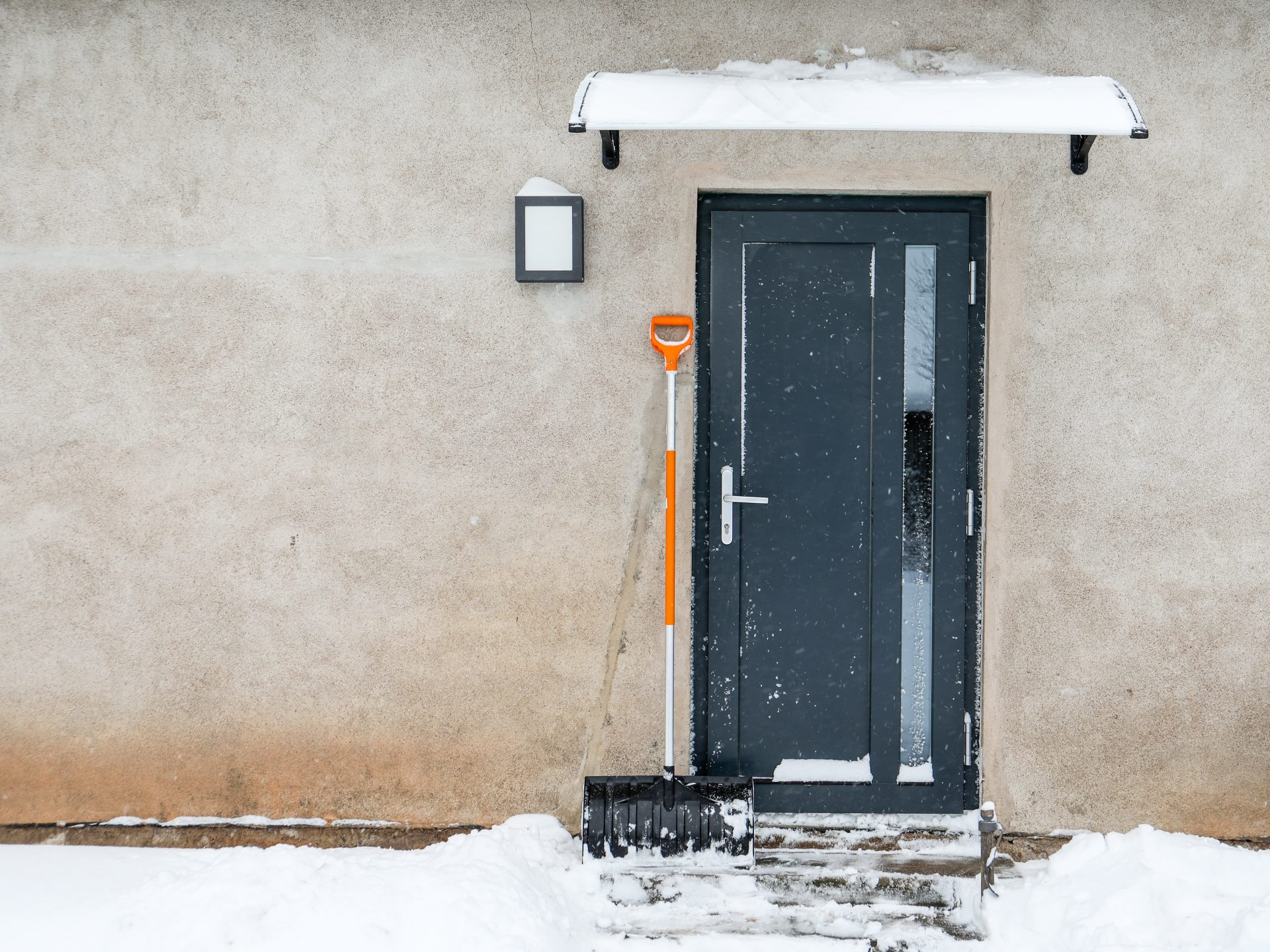 New durable front entry door on Alberta home during snowstorm by GreenFox Windows & Doors