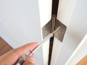 Professional Entry Door Repairs in Alberta – GreenFox Windows & Doors Entry door hinge adjustment performed by GreenFox Windows & Doors in Alberta, ensuring proper door function.
