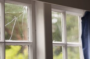 Damaged residential window in need of replacement, showcasing GreenFox Windows & Doors' repair services in Edmonton.