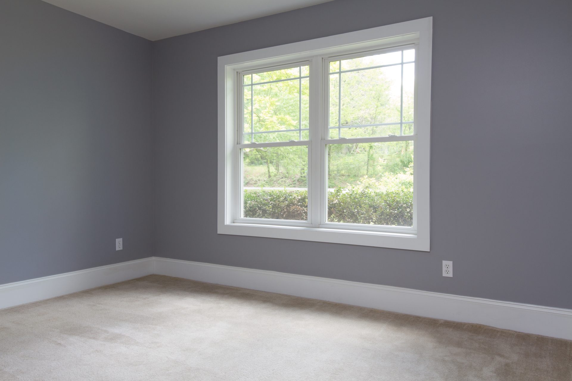 White window replacement in an empty gray room by GreenFox Windows & Doors in Fort Saskatchewan New Construction