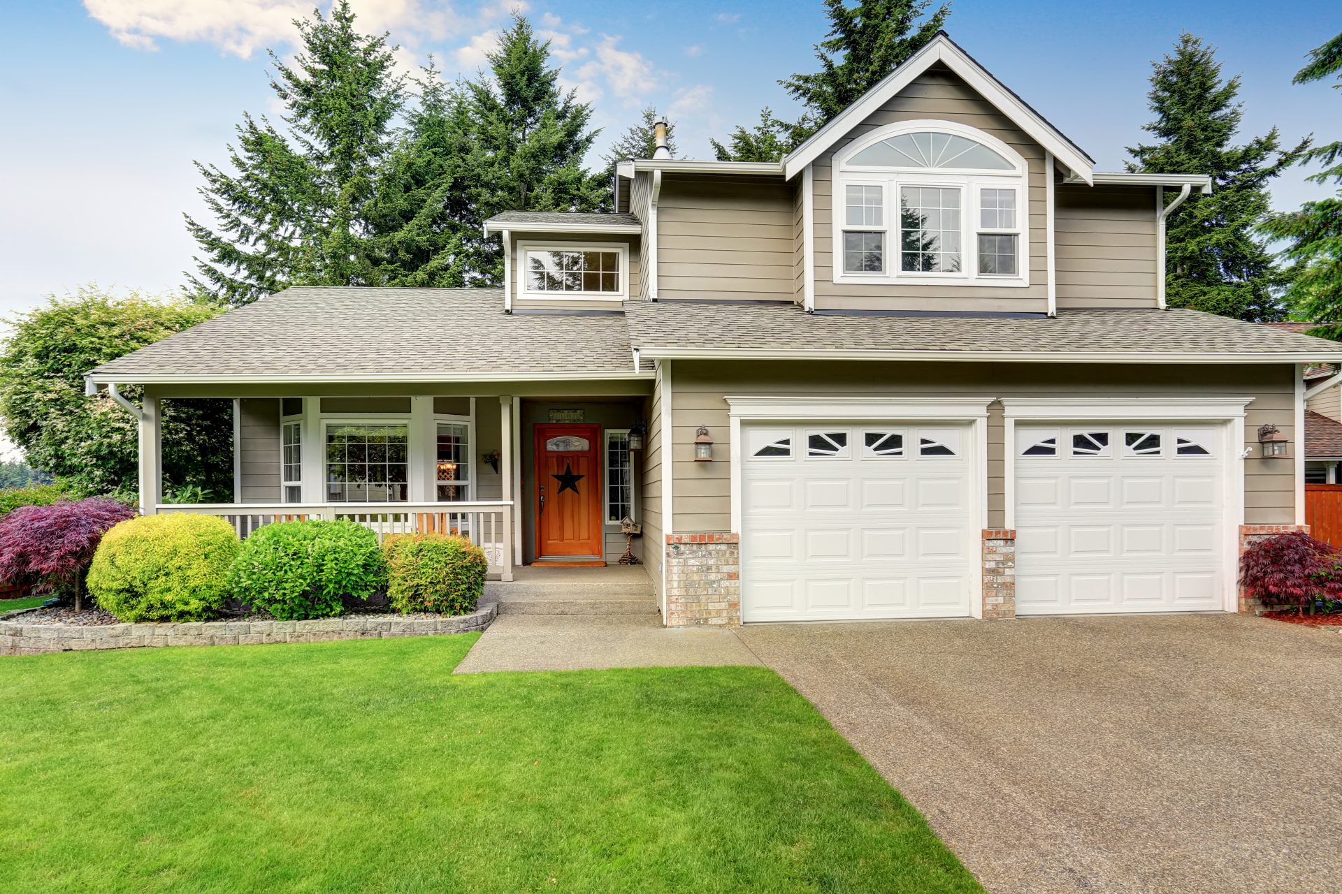Two-story tan house with white double garage