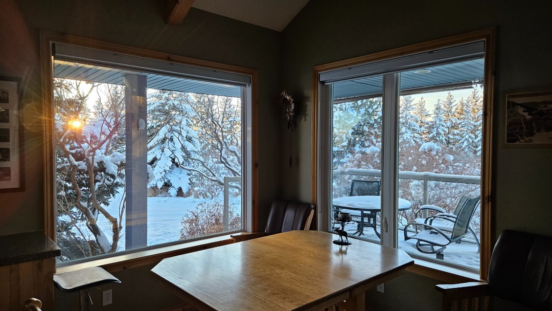 A view of two of Meryle L.’s new windows in a corner dining area