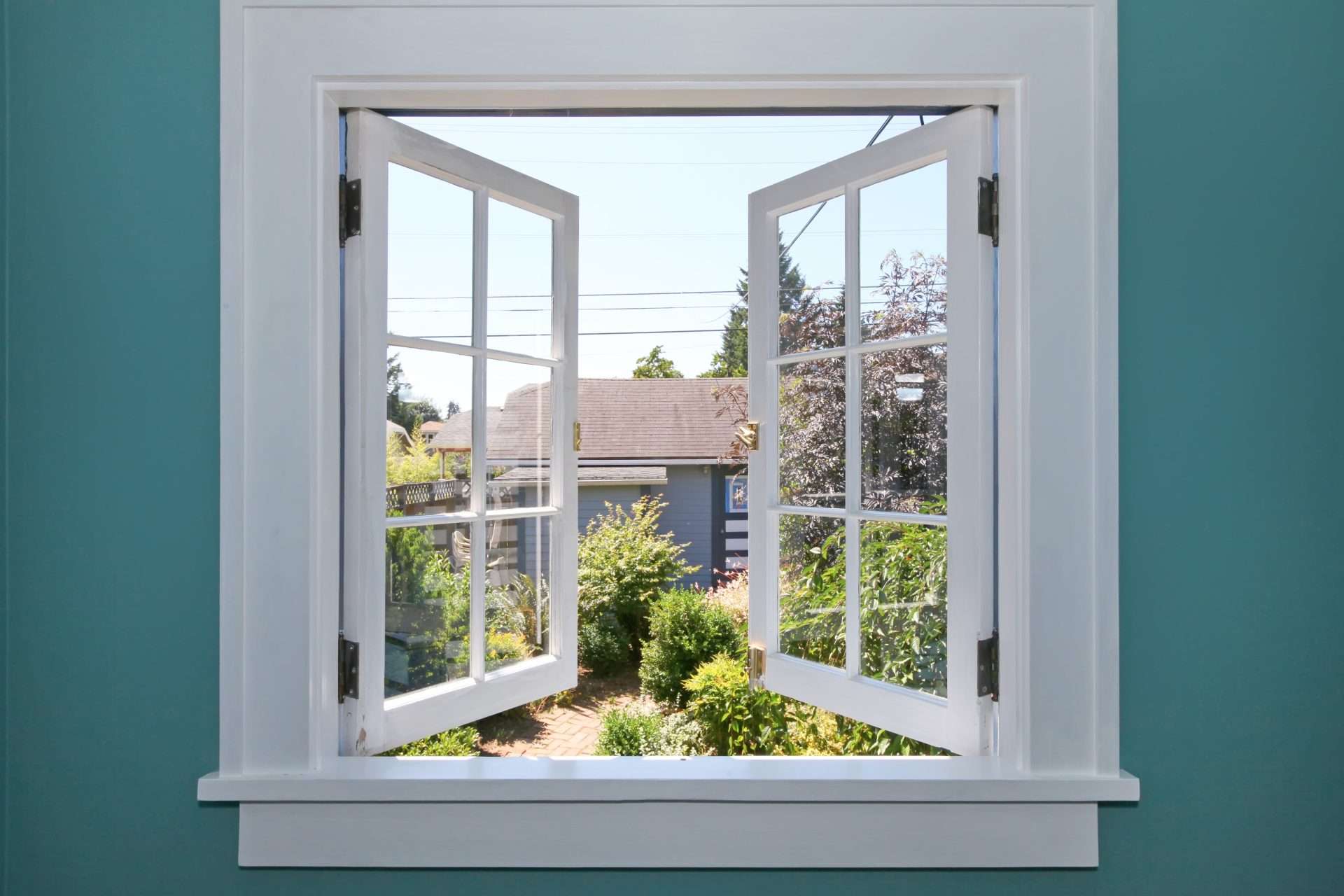 Open windows looking at a backyard after a window replacement by GreenFox Windows and Doors in Fort Saskatchewan