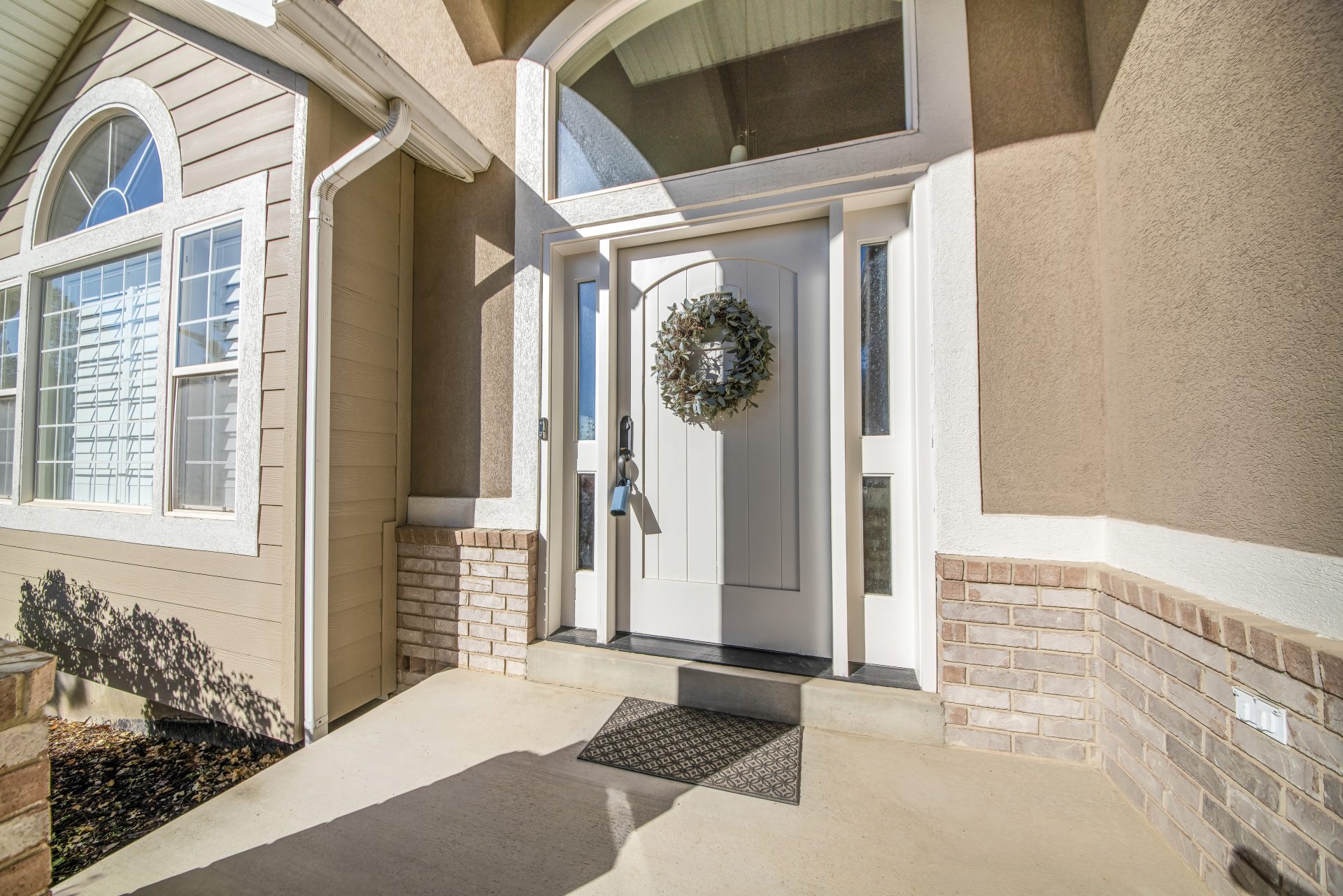 Entryway of luxurious Alberta home with white entry door
