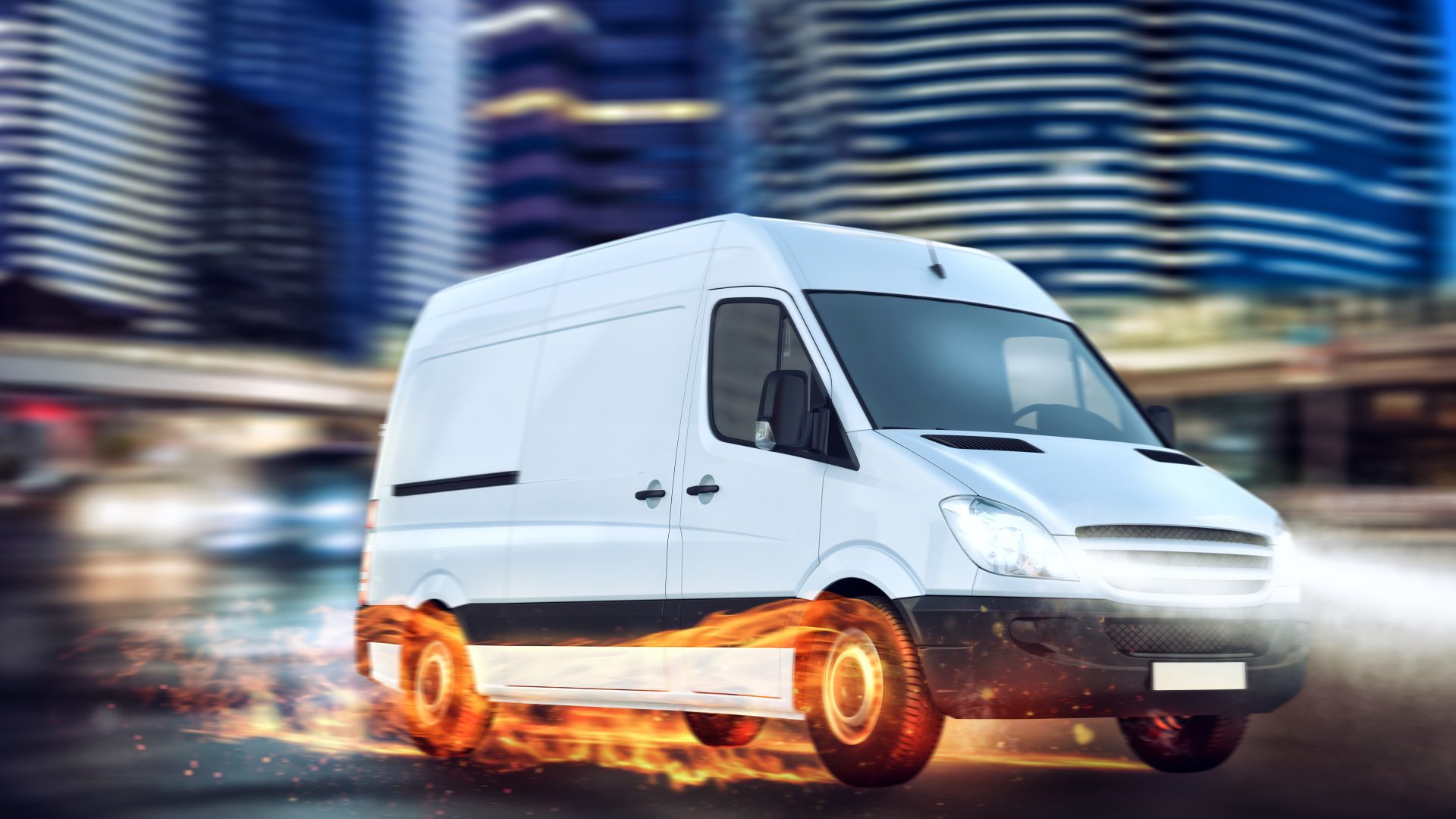 Close view of a white van against the motion-blur backdrop of a city scene. The van’s tires are on fire, giving the impression of extreme speed.