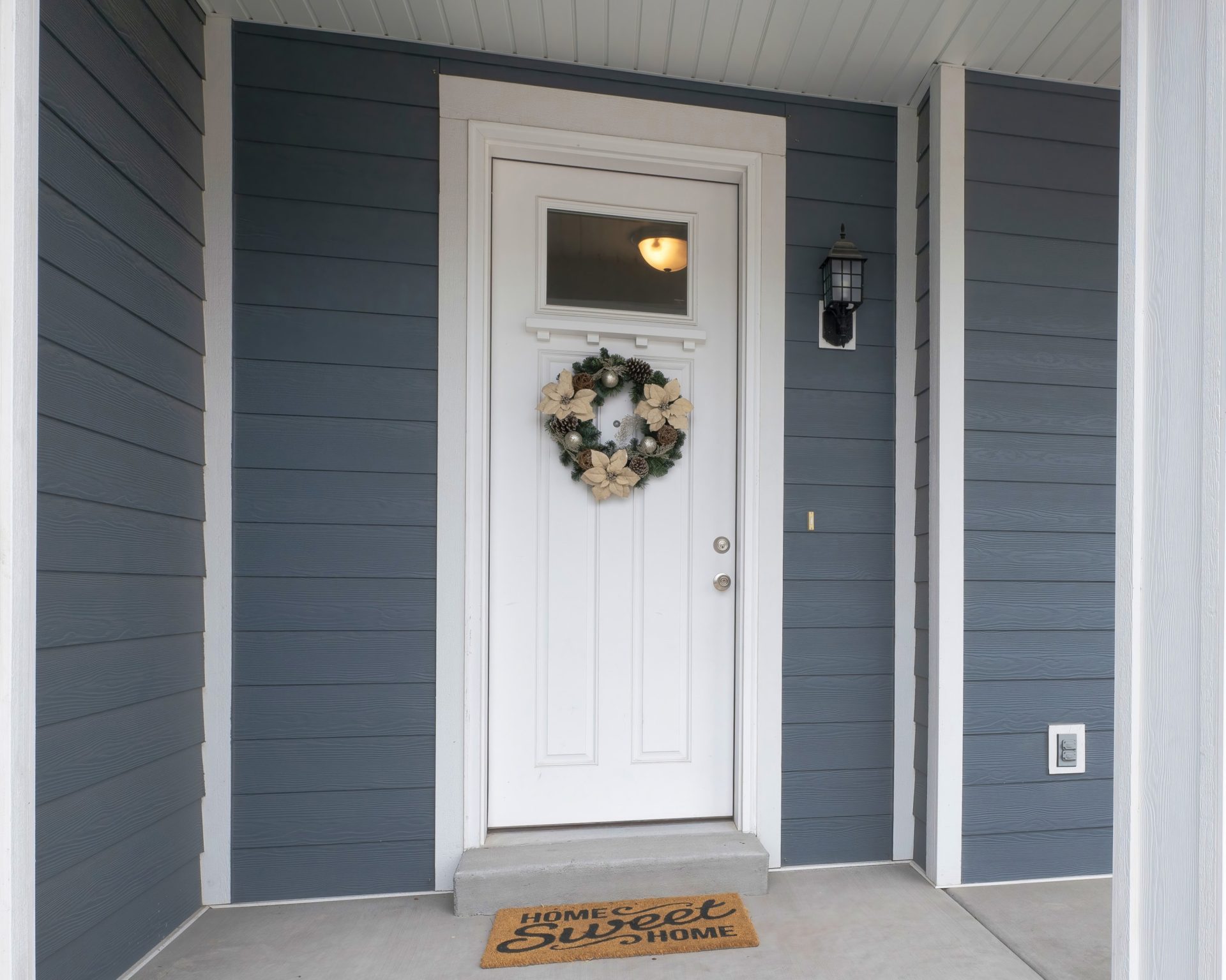 New white entry door on blue house in Alberta