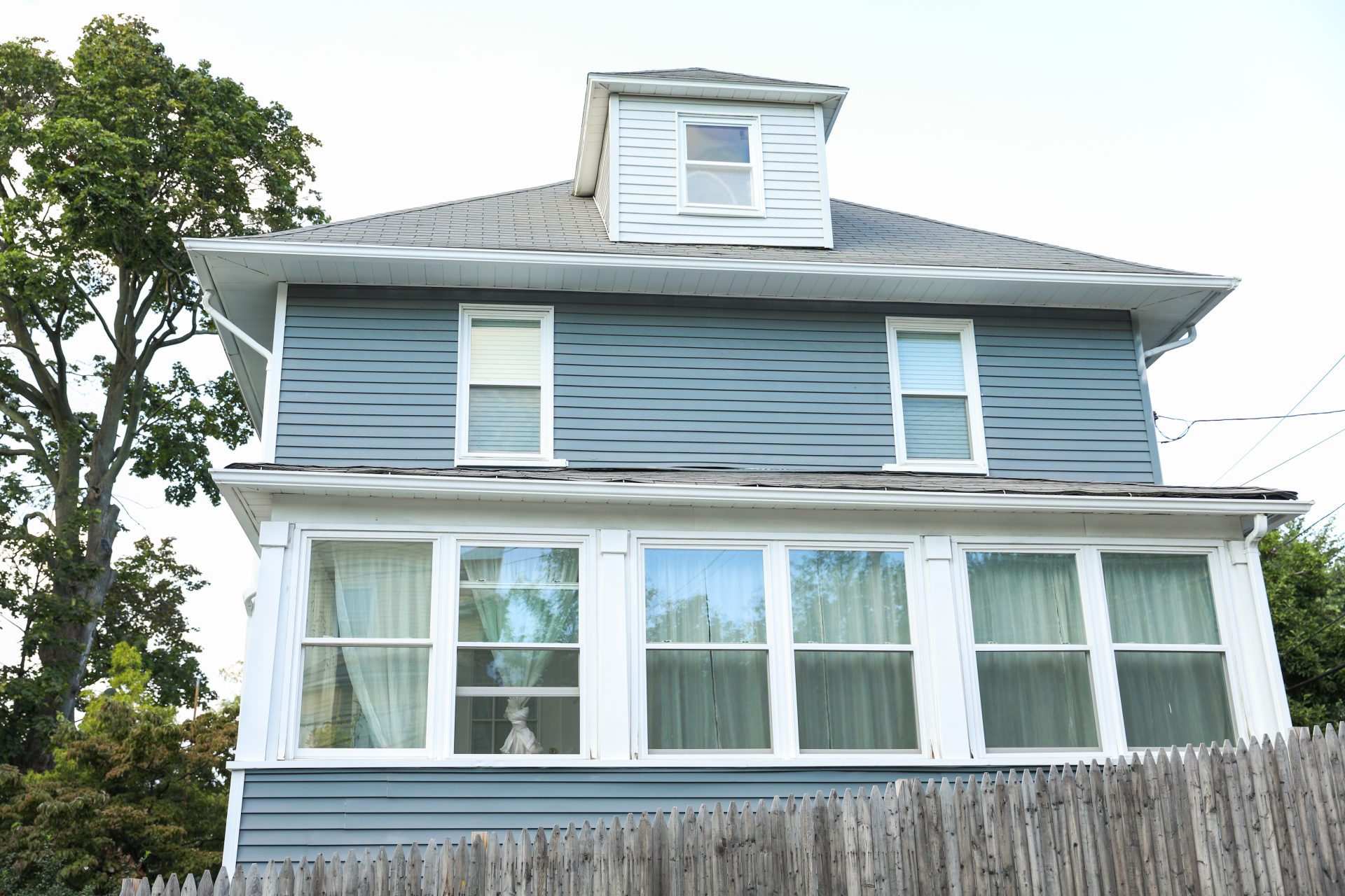 Beautiful windows on blue siding house In Okotoks, AB | GreenFox Windows & Doors