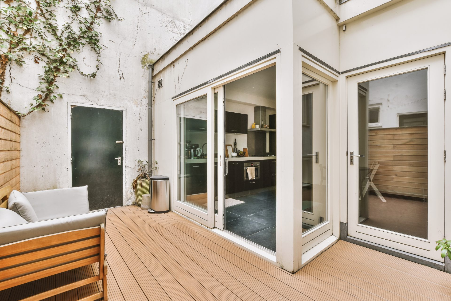 White sliding patio doors leading out onto wooden deck In Medicine Hat, AB