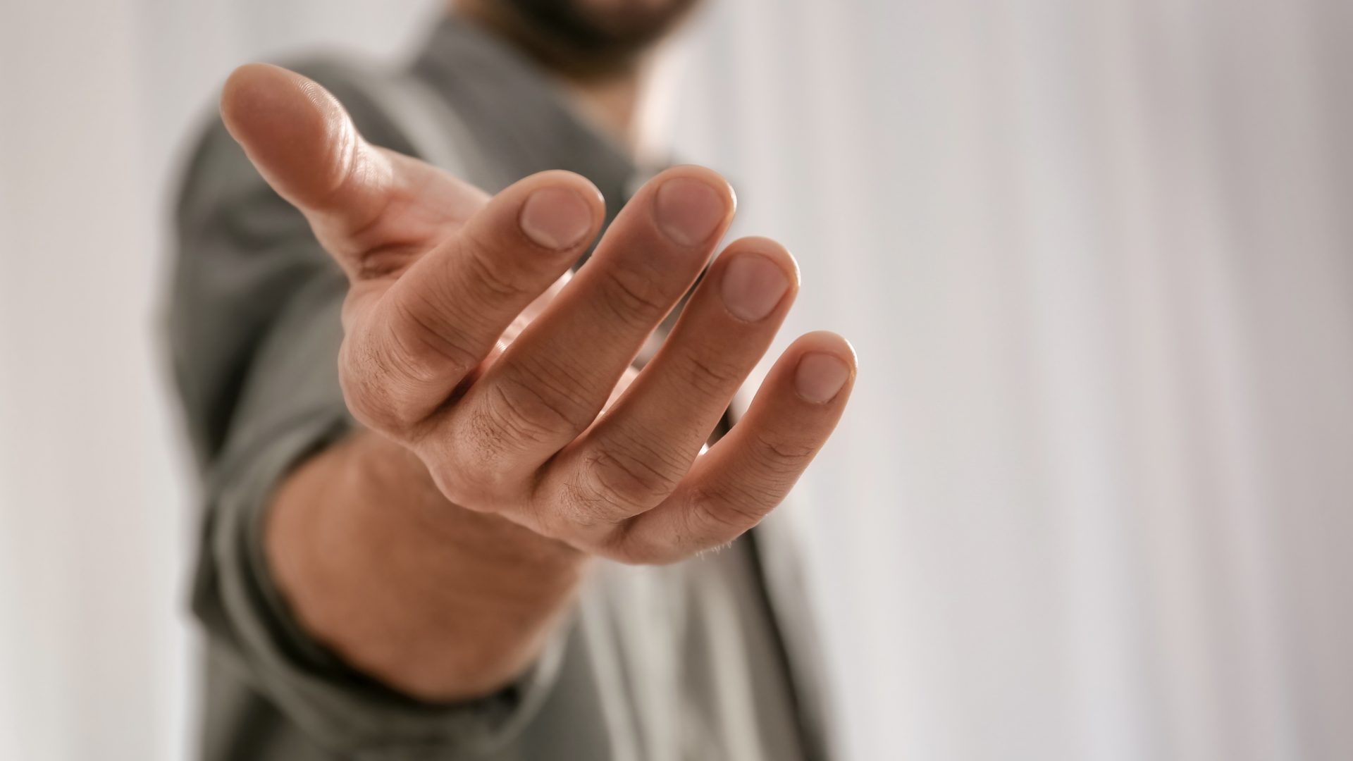 Close view of a man extending his hand in a gesture of help