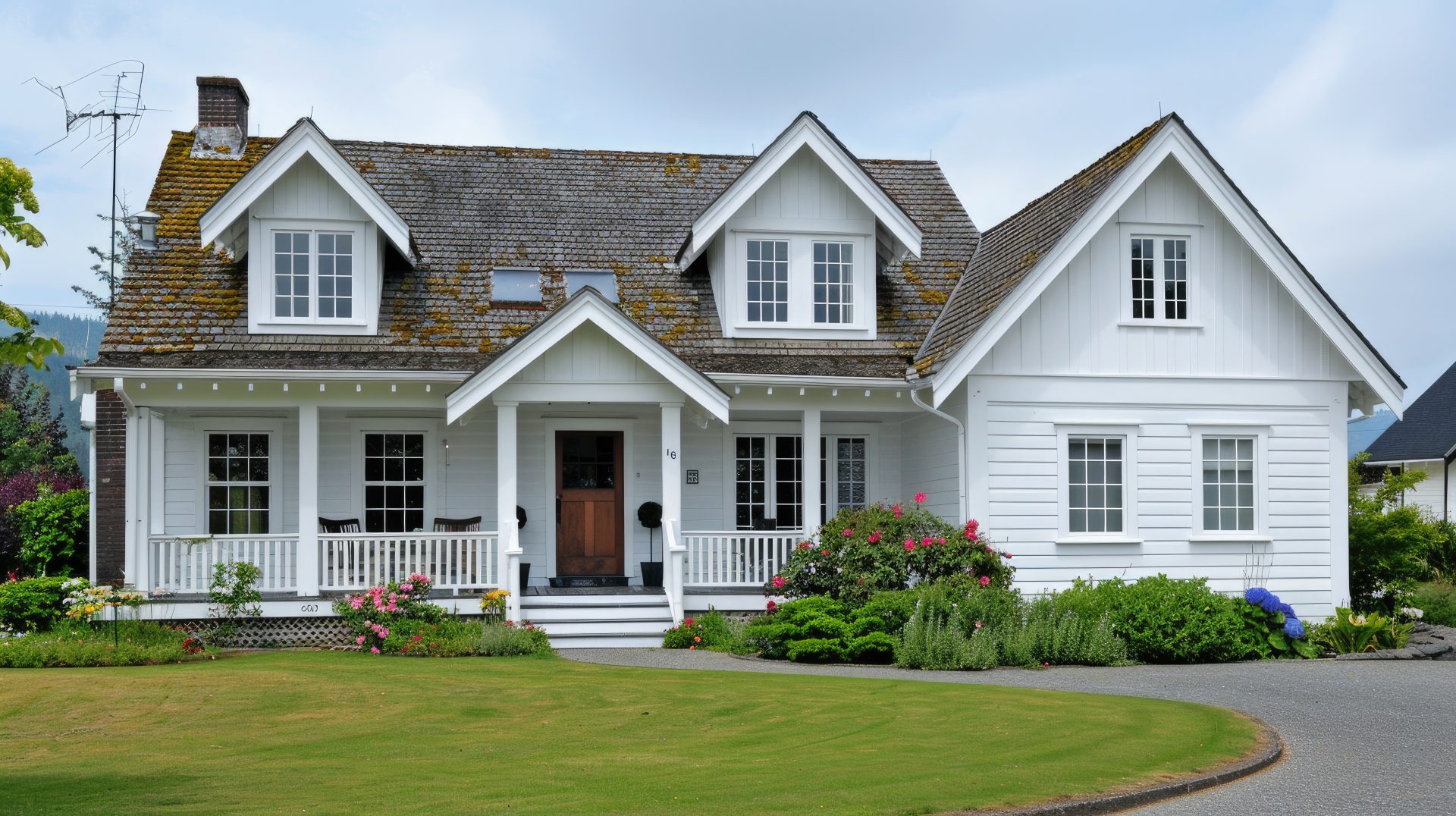 A two-story white house with several windows and a wooden door