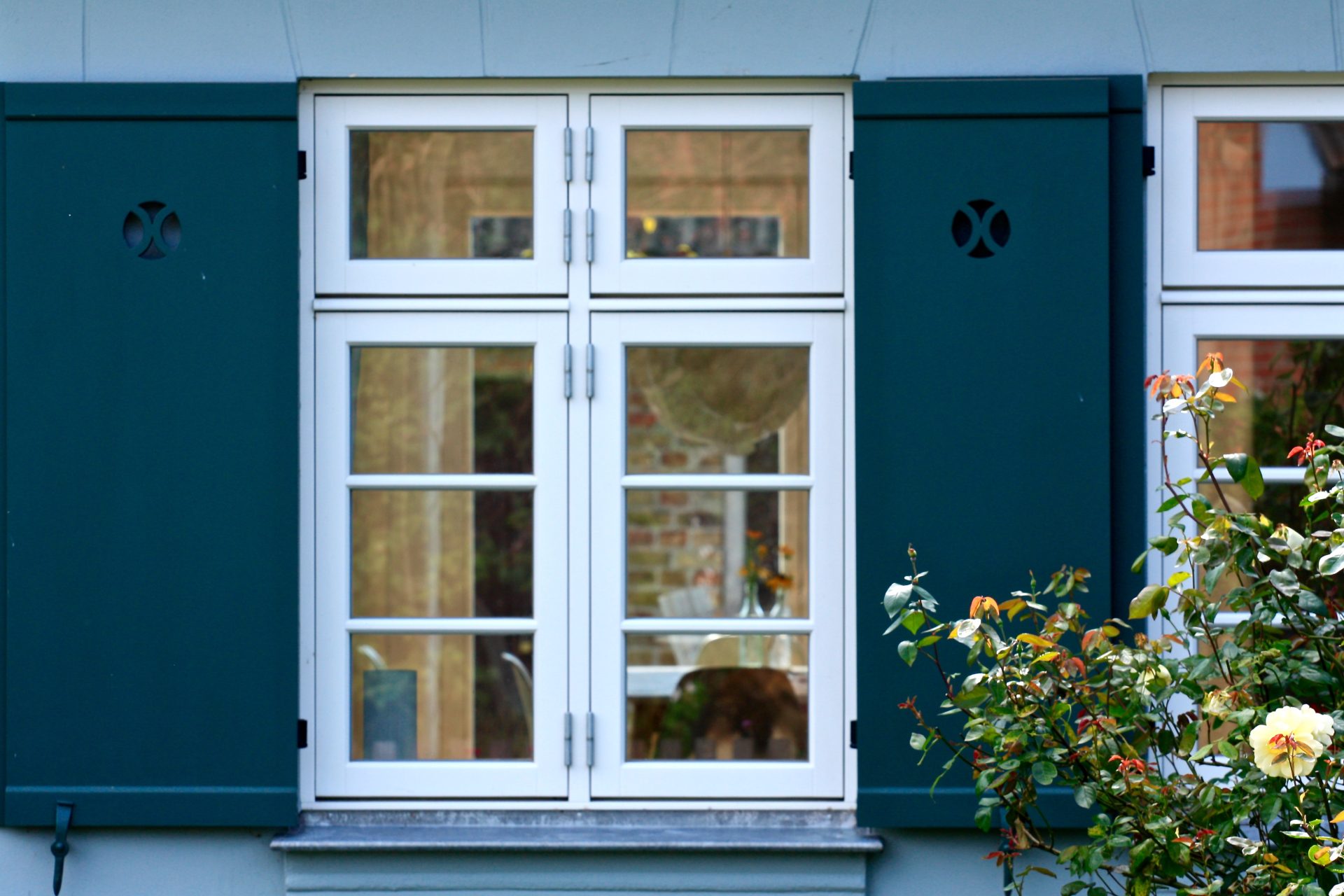 French doors leading out to a deck on the back of a brick house In Cold Lake, AB