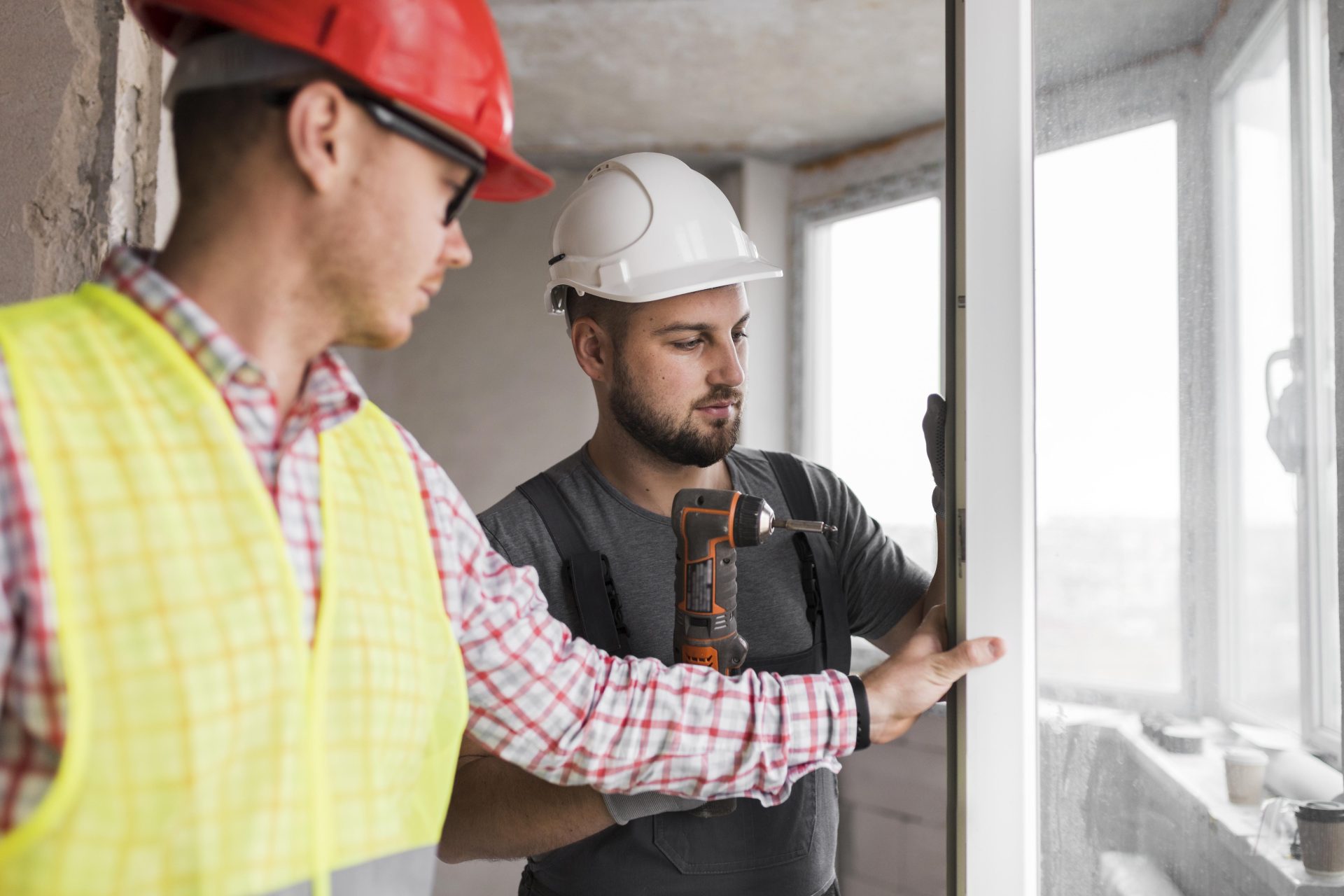 Two workers installing a new door in a home