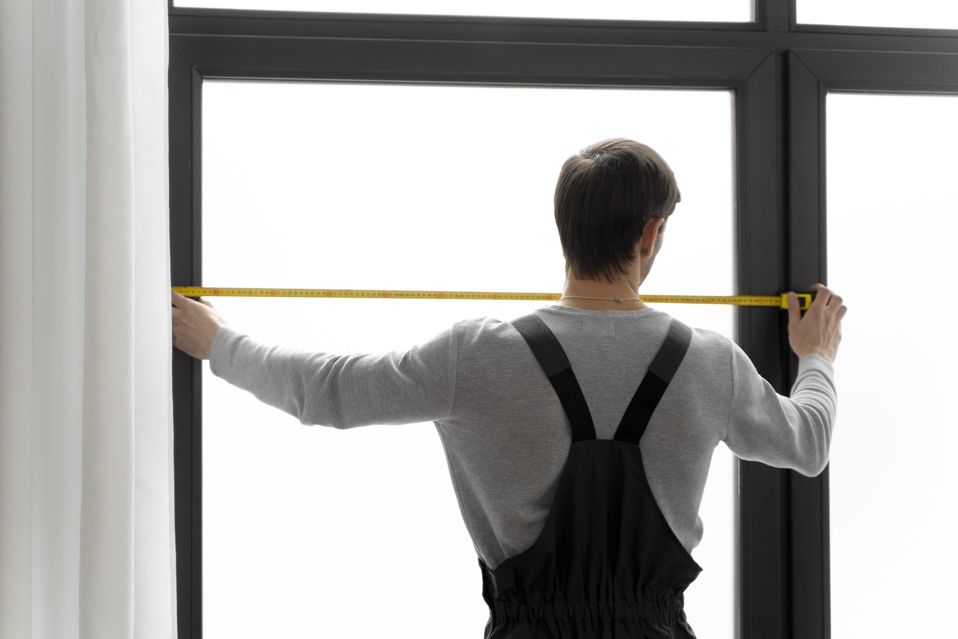 Technician working on a window during a sunny day