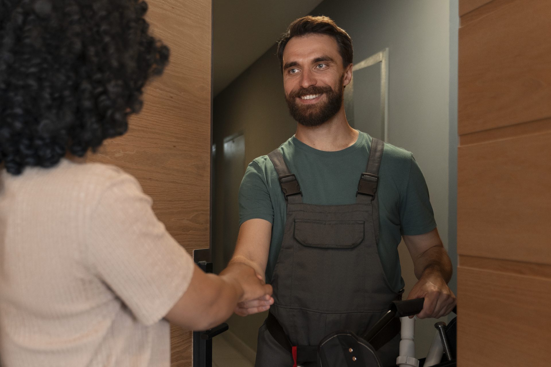Technician being greeted at the door of a home